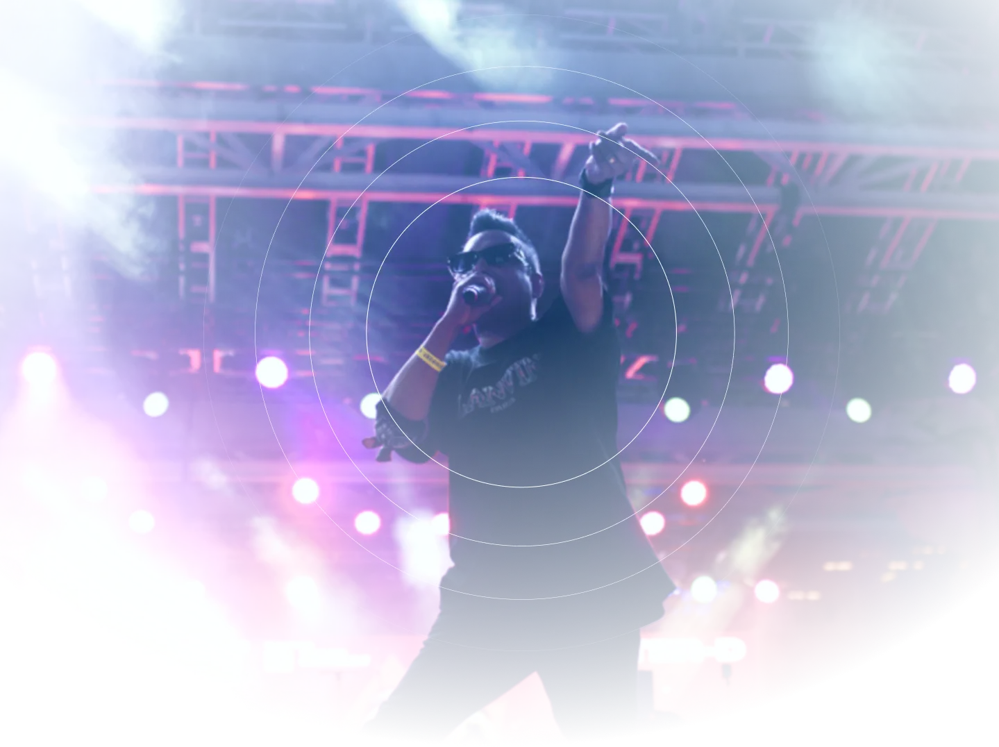 A DESIFEST artist performing on stage under neon lights